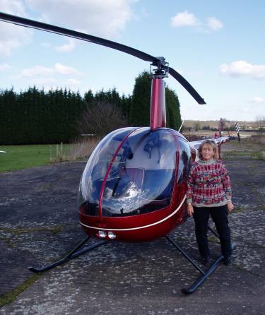 Picture of Helen Kraser alongside her helicopter. Picture of Helen Kraser alongside her helicopter.