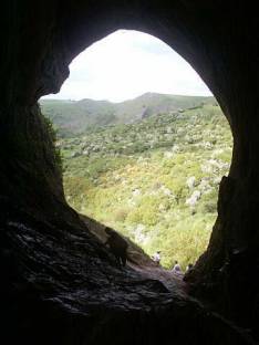 Picture from inside Thor's cave with the mouth of the cave in inverse silhouette. Picture from inside Thor's cave with the mouth of the cave in inverse silhouette.
