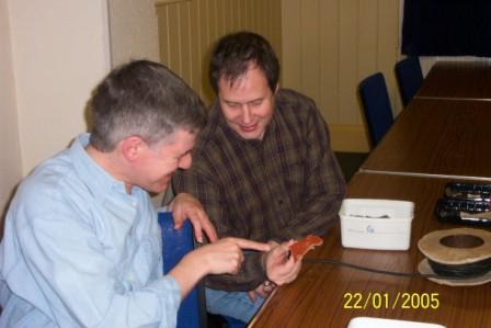 Picture of two people inspecting a piece of pottery Picture of two people inspecting a piece of pottery
