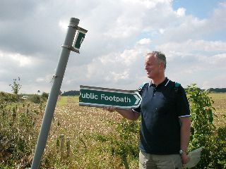 Picture of a public footpath sign split in two Picture of a public footpath sign split in two