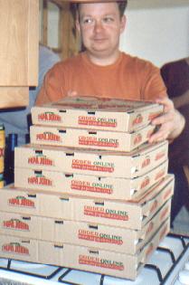 Picture of Andy behind a large pile of pizza boxes Picture of Andy behind a large pile of pizza boxes