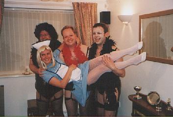 Picture of three the group in high heels and suspenders holding a fourth in nurse's outfit Picture of three the group in high heels and suspenders holding a fourth in nurse's outfit