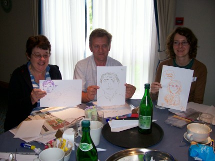 Three members show off their cartoon artwork. Three members show off their cartoon artwork.